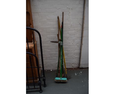 A selection of vintage tools together with a metal watering can and other gardening accessories