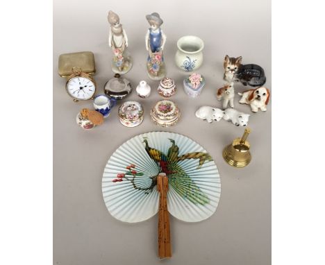 A mixed lot consisting of a quantity of ceramic figurines including a boy and a girl pushing a wheelbarrow, several figures o