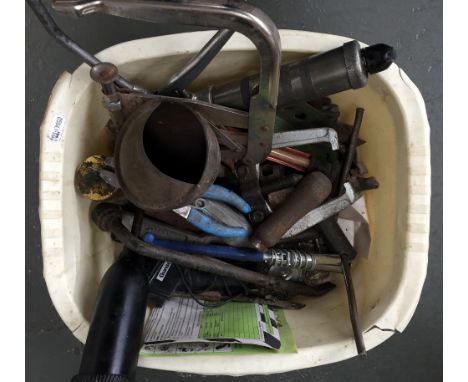 A selection of tools such as clamps and chisels together with several oil syringes