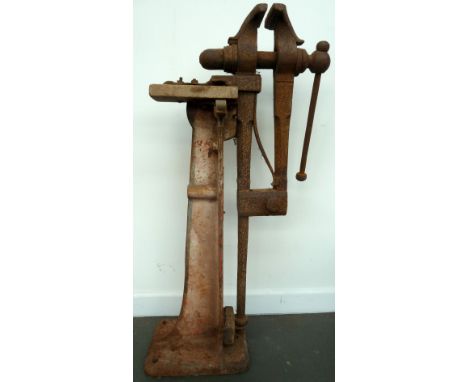 A vintage floor mounted cast iron vice 106cmH