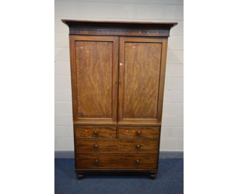 A GEORGIAN MAHOGANY AND INLAID LINEN PRESS, the panelled double doors enclosing four linen slides, above two short over two l