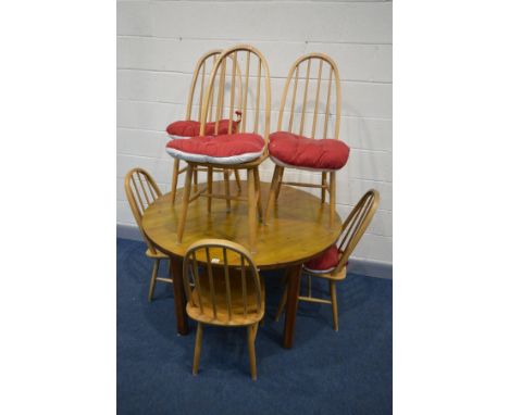 A PINE CIRCULAR DINING TABLE, diameter 123cm x height 74cm and six Ercol style quacker back chairs (7)