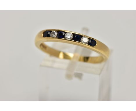 AN 18CT GOLD SAPPHIRE AND DIAMOND HALF ETERNITY RING, designed with a row of channel set circular cut blue sapphires interspa