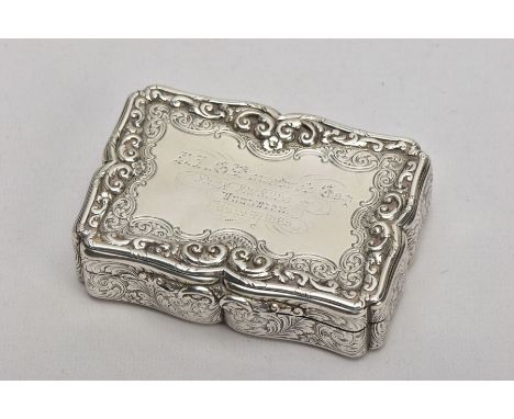 A NATHANIEL MILLS SILVER TABLE SNUFF BOX, a rectangular wavy edge box with a detailed embossed scroll and foliate design, gil