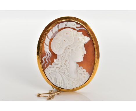 A YELLOW METAL CAMEO BROOCH, the brooch of an oval form, set with a carved shell cameo depicting the Greek goddess Athena, wi
