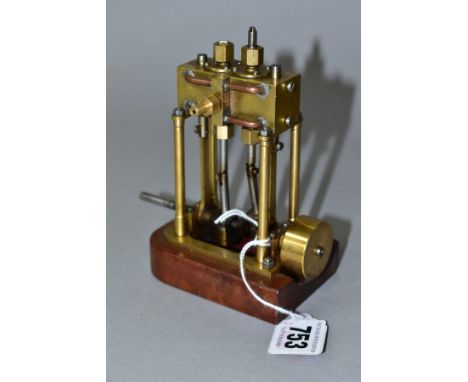 A VERTICAL TWIN CYLINDER LIVE STEAM MODEL OF A MARINE ENGINE, not tested, of brass and steel construction with copper piping,