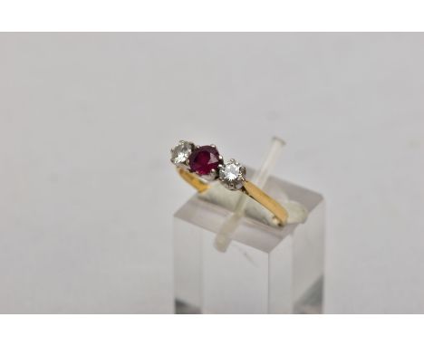 AN 18CT GOLD, RUBY AND DIAMOND THREE STONE RING, designed with a central circular cut ruby, flanked with round brilliant cut 