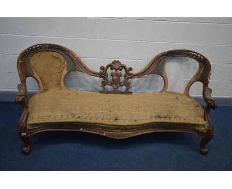 A VICTORIAN WALNUT OPEN DOUBLE BACK SOFA, the frame carved with foliate scrolls, shield centre splat, and serpentine front, l