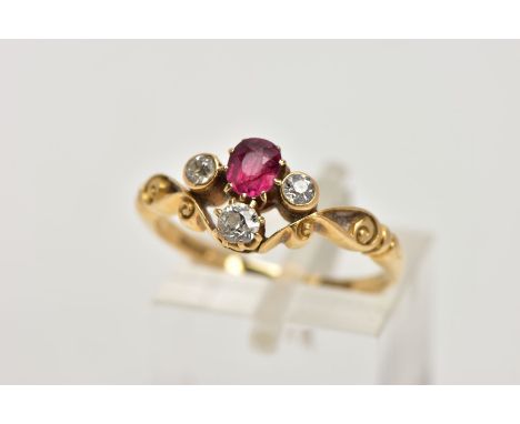 A YELLOW METAL RUBY AND DIAMOND DRESS RING, designed with a cushion cut ruby, flanked with old cut diamonds each within a col