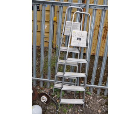 A PAIR OF ALUMINIUM STEP LADDERS 166cm and 164cm high respectively