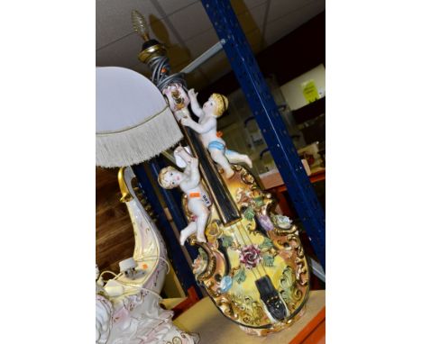 A LARGE CONTINENTAL PORCELAIN LAMP BASE, in the form of a violin with putti and encrusted with roses (nibbles), approximate h