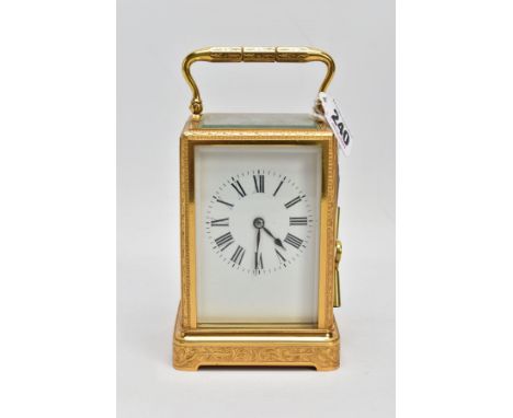 A BRASS CARRIAGE CLOCK, white dial, Roman numerals, five glass panels, engraved floral and foliate design to the frame, appro