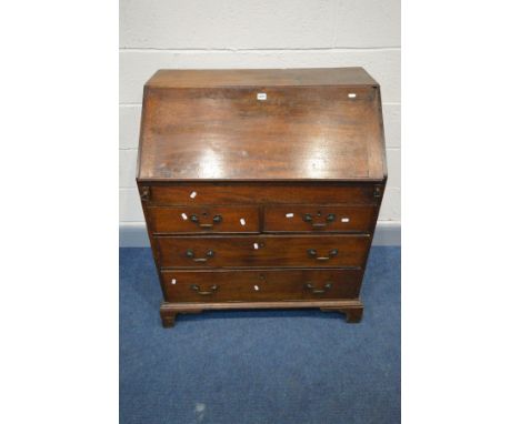 A GEORGIAN OAK BUREAU, the fall front enclosing a fitted interior, two short over two long drawers, drop handles, on bracket 