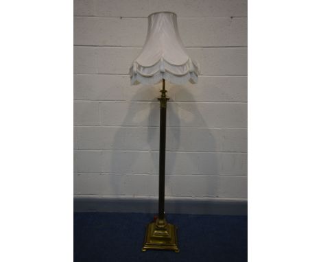 A BRASS CORINTHIUM COLUMN TELESCOPIC STANDARD LAMP, with a fabric shade