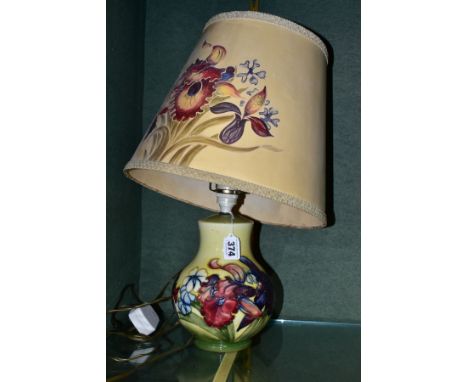 A MOORCROFT POTTERY SQUAT BALUSTER TABLE LAMP, in the Spring Flowers design, on pale yellow ground, impressed marks to the ba