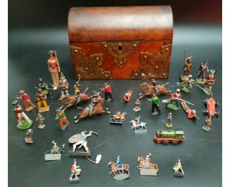 A Victorian tea caddy box contains antique lead soldiers 