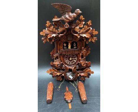 A Carved style Black forest quartz cuckoo clock with chamois &amp; hunter by Trenkle Uhren [44cm] 