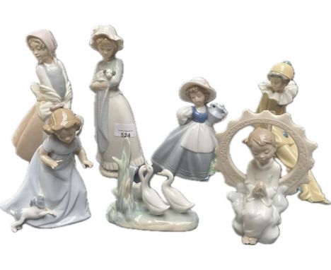 A collection of seven Nao figures; Nao wandering minstrel clown &amp; Jesus loves you 