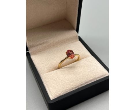 10ct yellow gold ring set with an oval cut fire opal. [Ring size P] [2.20Grams] 