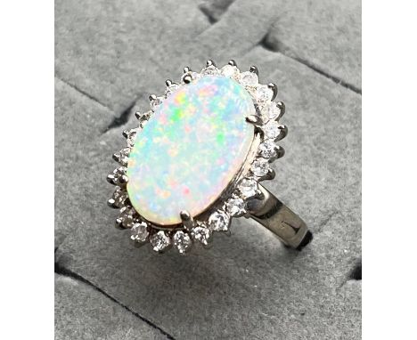 14ct white gold ladies ring set with an oval cut large opal stone surrounded by 0.64cts of diamonds. Opal 3.22cts [Opal-17x11