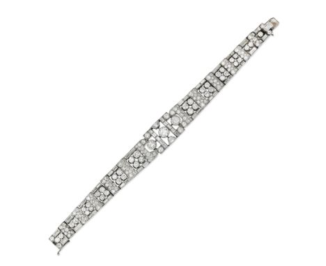 ART DECO DIAMOND BRACELET/BROOCH, CIRCA 1930Of openwork geometric design, set with brilliant, old brilliant, baguette and tra