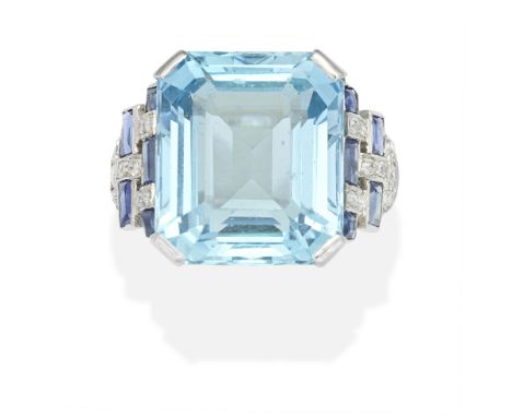 AQUAMARINE, SAPPHIRE AND DIAMOND RINGThe octagonal, step-cut aquamarine, between geometric shoulders, set with baguette and s