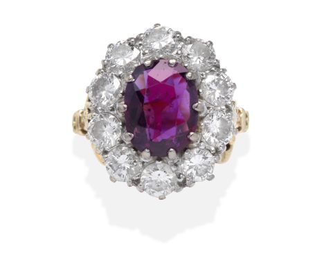 RUBY AND DIAMOND CLUSTER RINGThe oval-cut ruby, within a brilliant-cut diamond surround, ruby approx. 2.70cts, diamonds appro