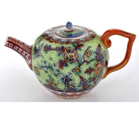 Toy teapot and cover, either Chinese or Meissen, c.1740, probably over decorated in England, height 5.3cm.