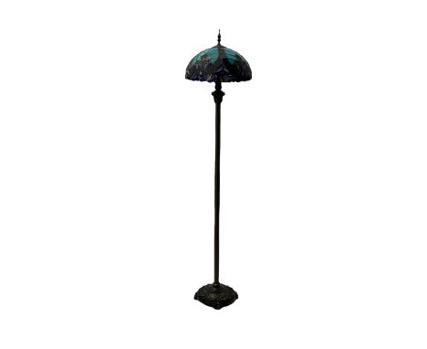 Early 20th century bronze effect floor lamp, Tiffany design domed stained glass shade with multicoloured geometric and floral