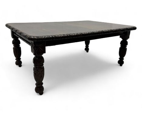 19th century heavily carved oak extending dining table, rectangular top with rounded corners and carved gadrooned edge, exten
