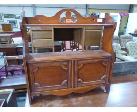 A walnut hanging wall cabinet enclosed by a pair of panel doors under a display shelf. 22 1/2' wide