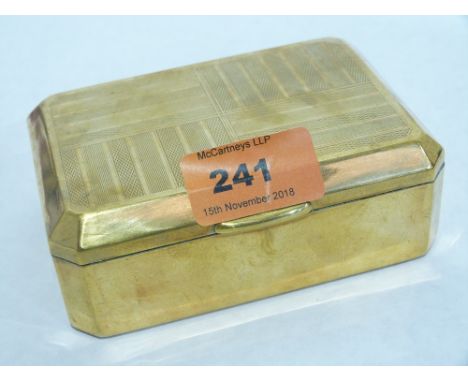 A brass engine turned cigarette box, the underside stamped Marcovitch Black and White Cigarettes. 4 1/2' wide