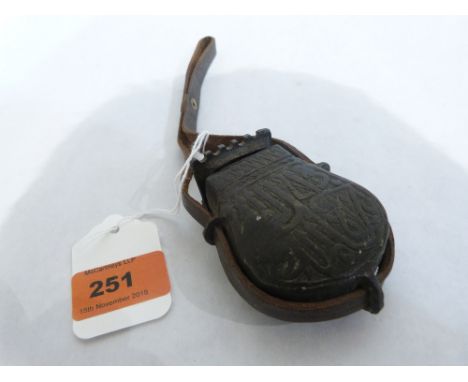 An Islamic bronzed metal powder flask. 3 1/2' high