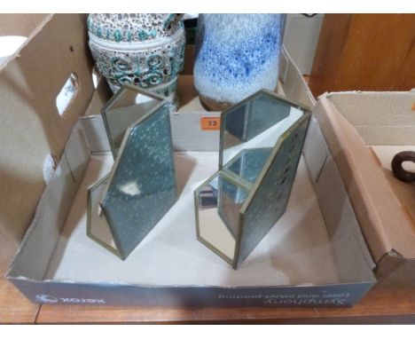 A pair of small mirrored trinket display stands
