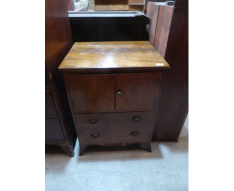 A George III mahogany night commode, enclosed by a pair of doors over a deep drawer on splayed bracket feet. 23' wide