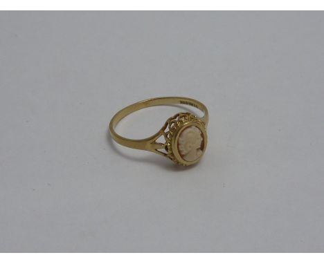 A 9CT GOLD CAMEO RING, the oval shape cameo of a woman in profile with scalloped surround with tri pronged to the plain taper