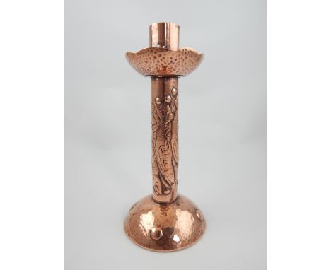 Newlyn copper candlestick, with planished drip pan and domed base, the column decorated with pilchards, impressed mark to bas