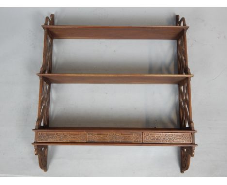 Early 20th C waterfall wall shelves, mahogany with cockpen sides, three drawers to lower shelf, 91 x 74cm.