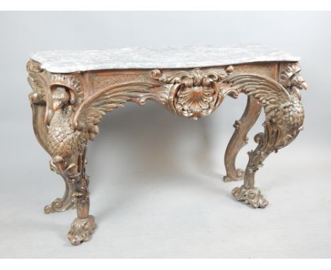 In the manner of Gillows, a colonial style silver console table variegated swept marble top, heavy padouk? wood base with car