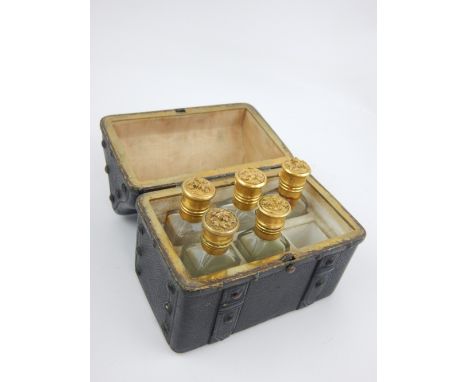 Late 19th century French scent bottle casket modelled as a miniature studded trunk, the compartmentalised interior housing fi
