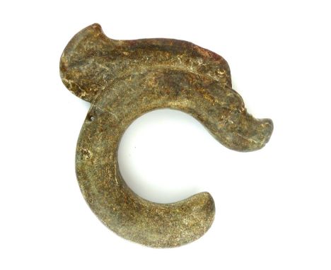 A large and heavy opaque Chinese jade dragon, the beast with wrinkled snout and sail crest, 23cm high.