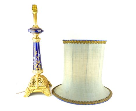 A gilt metal mounted porcelain ''candlestick'' table lamp, with silk shade.