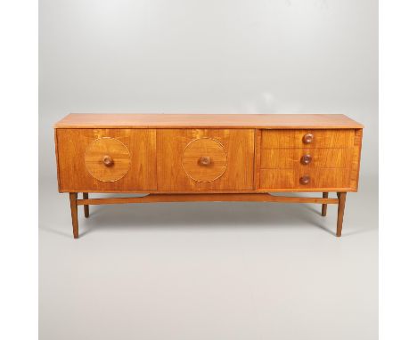 A large sideboard with two cupboard doors with circular panels and internal shelf, with three drawers and supported on taperi