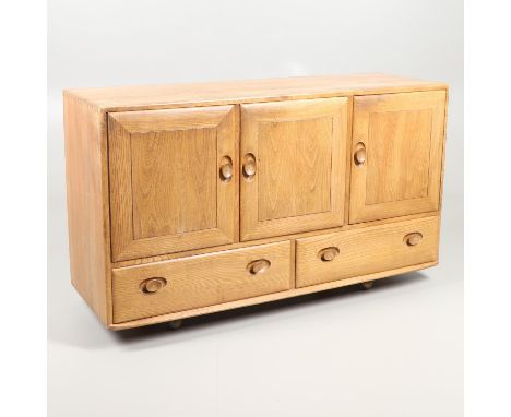 A light elm sideboard with two large cupboard doors and internal shelf, with flanking single cupboard and cutlery drawer. Wit