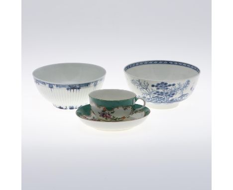 A cup and saucer painted with sprays of flowers within a gilt edged panel, and on a green ground. With pseudo 'Meissen' marks