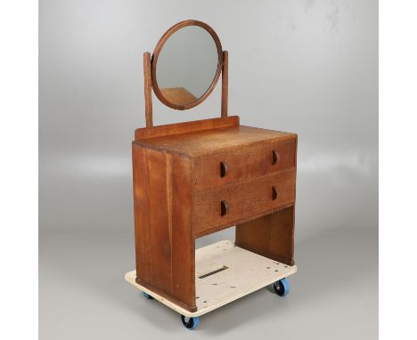 The dressing chest with two drawers and curved handles, with a small backboard and circular mirror. With a 'Heals' button to 
