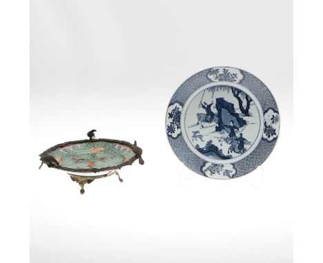A 20thc copy of a Kangxi dish, painted with figures on horseback hunting a deer in a landscape, the border painted with panel