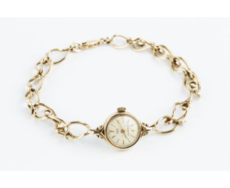 A LADY'S 9CT GOLD BRACELET WATCH, the circular silvered dial with baton markers, signed Ernest Borel and Mappin, to a jewelle
