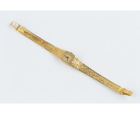 A LADY'S 9CT GOLD BRACELET WATCH BY OMEGA, the cushion-shaped dial with baton markers, to a jewelled calibre 485 manual wind 