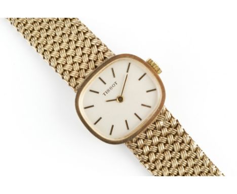 A LADY'S 9CT GOLD BRACELET WATCH BY TISSOT, the cushion-shaped dial with baton markers, to a jewelled manual wind movement, o